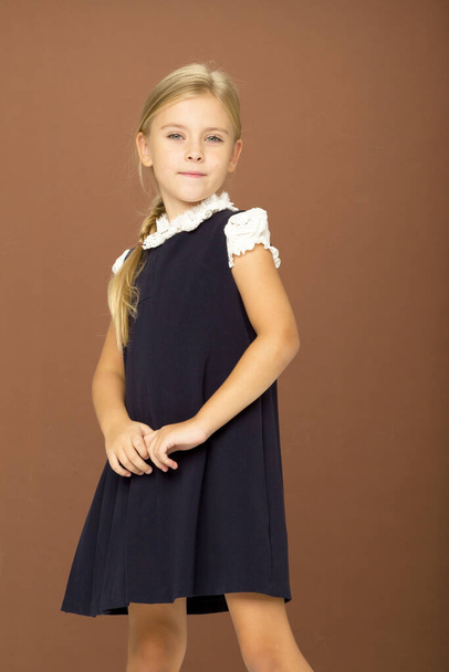 Cute cheerful schoolgirl in uniform - Foto, imagen