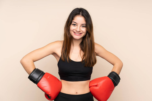 Young sport woman with boxing gloves over isolated background - Zdjęcie, obraz