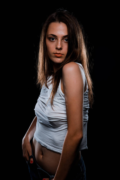 Portrait of a beautiful stylish girl wearing white top - Foto, afbeelding