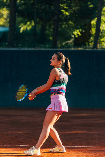 Vertical full-length view of a sportswoman playing  match on the tennis court - Photo, Image