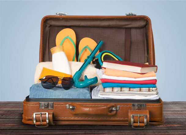 Packed vintage suitcase full of vacation items - Foto, Imagem