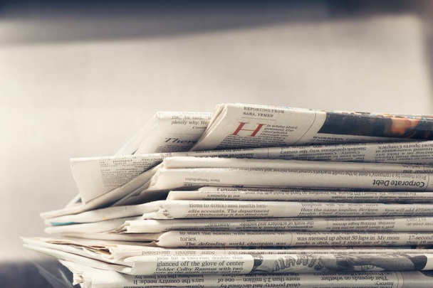 Pile of newspapers stacks on blur background - Фото, изображение