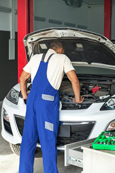 Auto Mechanic Checking the Engine of a Car - Photo, image