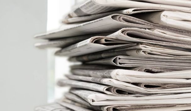 Pile of newspapers on white background - Фото, изображение