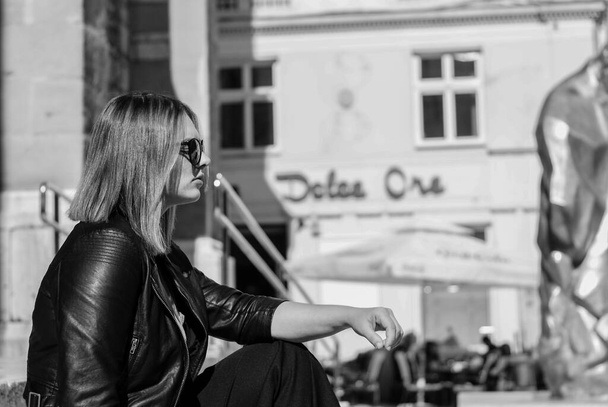 SARAJEVO, BOSNIA AND HERZEGOVINA - Jul 05, 2017: Beautiful girl black and white photography on street of Sarajevo - Zdjęcie, obraz