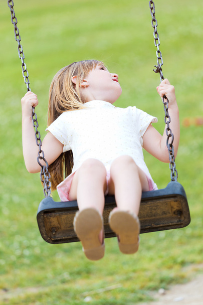 Happy little girl having fun in the park. - Фото, зображення
