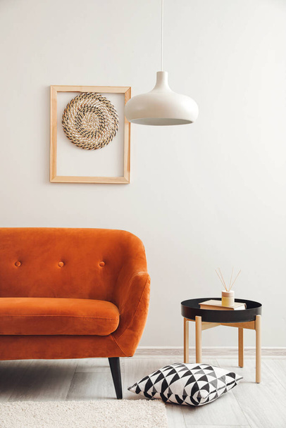 Stylish sofa and table near light wall - Photo, Image