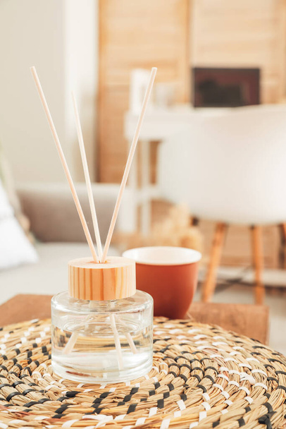 Reed diffuser on ottoman in room - 写真・画像