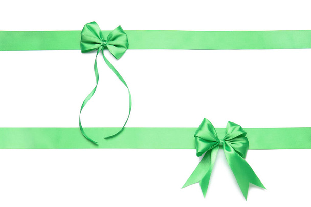 Beautiful green ribbons with bows on white background - Photo, Image