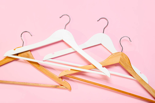 Stylish clothes hangers on color background - Photo, Image