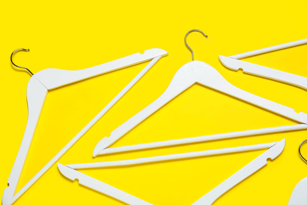 Stylish clothes hangers on color background - Photo, Image