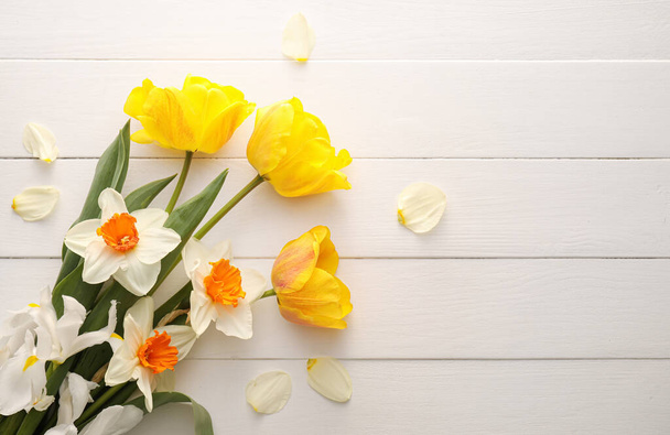 Beautiful flowers on light wooden background - Foto, Imagem