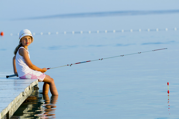 Fishing - lovely girl fishing on the pier - Photo, Image