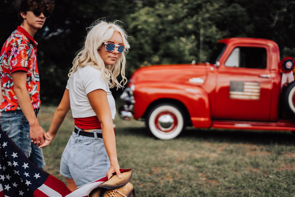 Couple in a vintage red truck - Фото, изображение