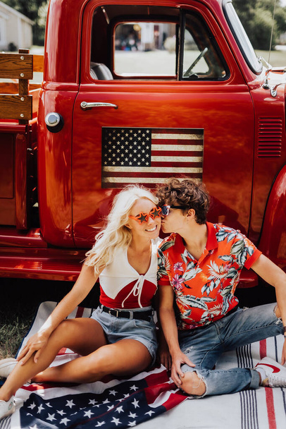 Couple in a vintage red truck - Фото, изображение