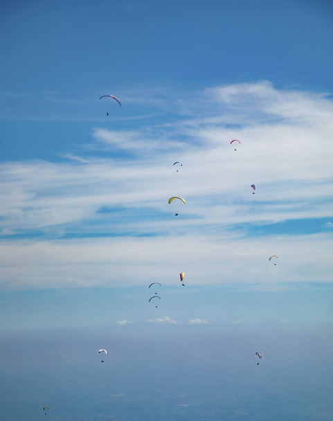 Group of paragliders in flight with background in blue sky - Photo, image