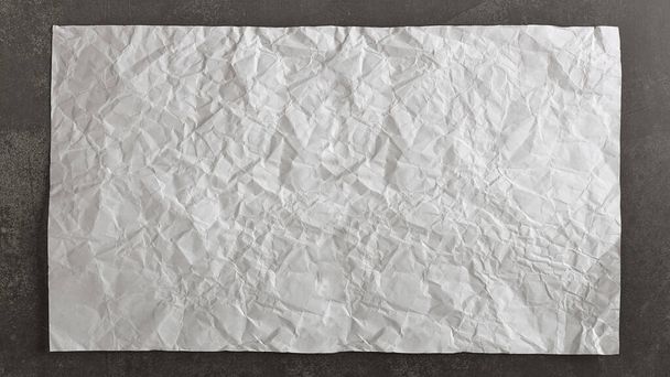 Old and crumpled sheet of paper on vintage black background. Abstract images with copy space. - Foto, immagini