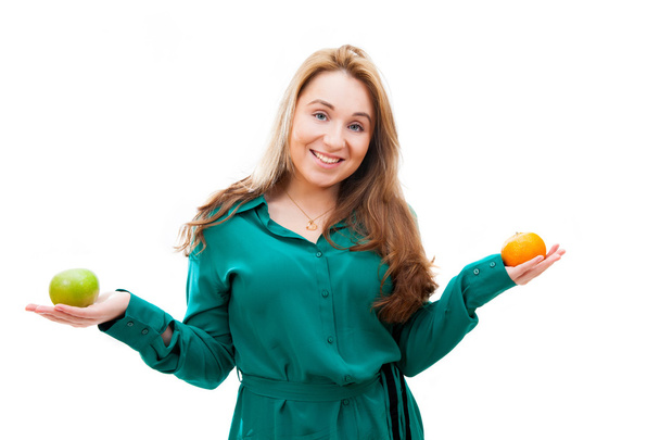 Girl with apple and tangerine - Valokuva, kuva
