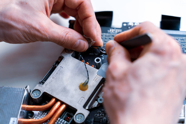 Computer service. Technology repair of pc electronic equipment. Technician engineer man do maintenance of hardware - Photo, Image