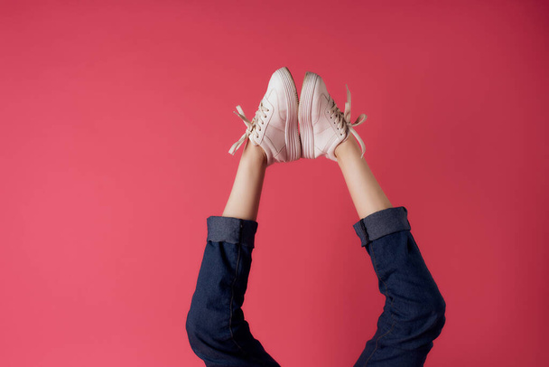 womens legs inverted in white sneakers street style - Fotografie, Obrázek