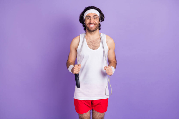 Photo of optimistic brunette guy stand with rape wear spectacles white hair band singlet shirts isolated on lilac color background - Fotografie, Obrázek