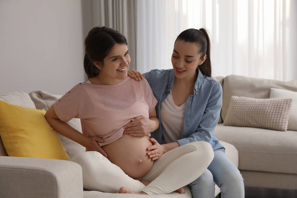 Doula working with pregnant woman in living room. Preparation for child birth - Foto, Imagen