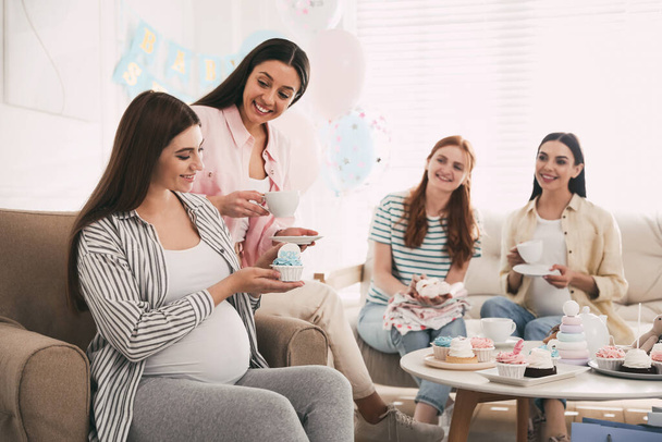 Happy pregnant woman spending time with friends at baby shower party - Foto, Imagen