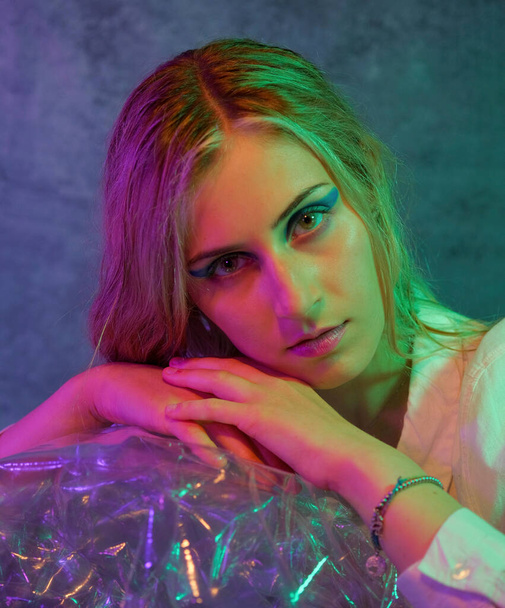 beautiful blonde italian girl posing in photo studio with colorful lights. High quality photo - Foto, afbeelding