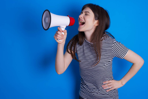 Funny young woman People sincere emotions lifestyle concept. Mock up copy space. Screaming in megaphone. - Photo, image