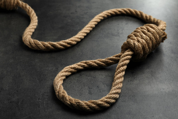 Rope noose with knot on grey table, closeup - 写真・画像