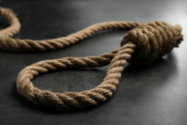 Rope noose with knot on grey table, closeup - Fotó, kép