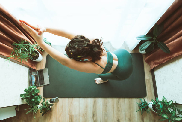 kobieta robi jogę w domu w pobliżu dużego okna zdrowy styl życia - Zdjęcie, obraz