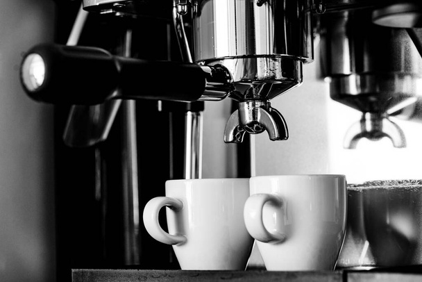 Close up image of professional espresso machine pouring in two cups - Фото, зображення