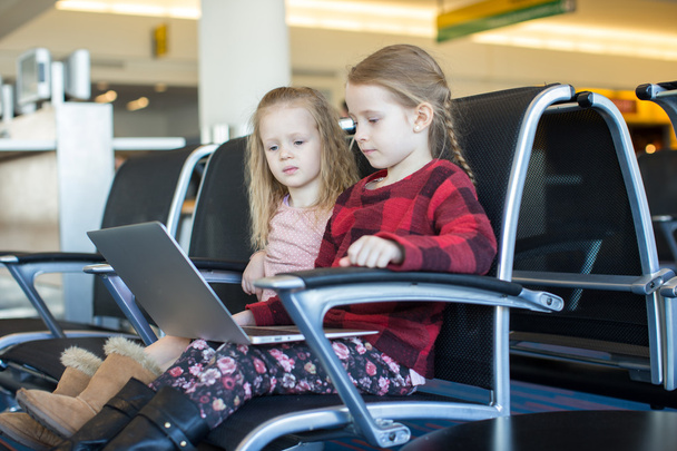 Kids with a laptop at the airport while waiting his flight - Фото, зображення