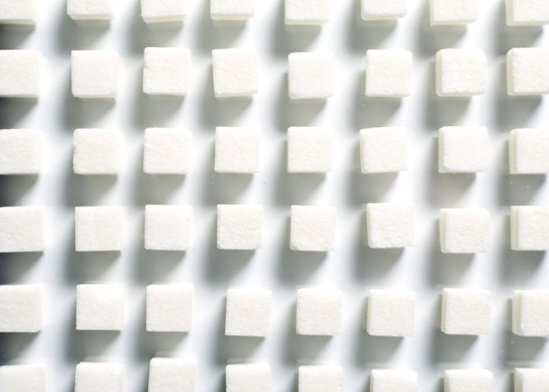 Pile of sugar cubes on white background - Foto, Imagen