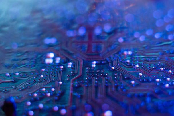 Computer motherboard, microchips close-up in color illumination, - Fotoğraf, Görsel