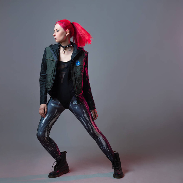 Futuristic fashion, a young bright and attractive woman with pink hair, - Fotografie, Obrázek