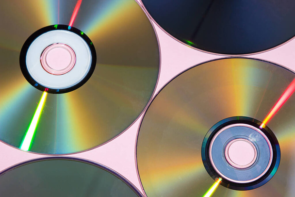 Compact discs on a pink background. Technologies of the past. Retro background - Photo, image