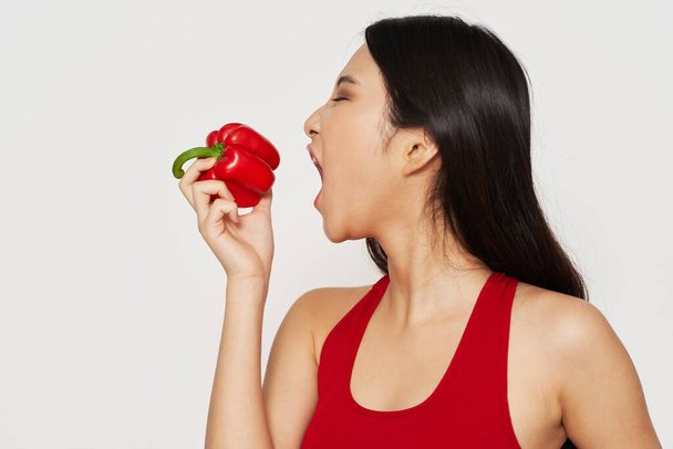 sportive woman holding bell pepper vegetables food diet - Фото, зображення