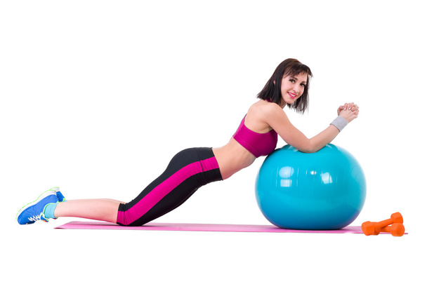 Young smiling woman makes exercise with fitball - 写真・画像