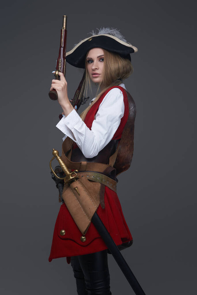 Boční pohled studio záběr ženy pirát s pistolí - Fotografie, Obrázek
