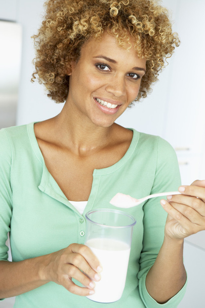 Mid Adult Woman Holding Dietary Supplements - Фото, изображение