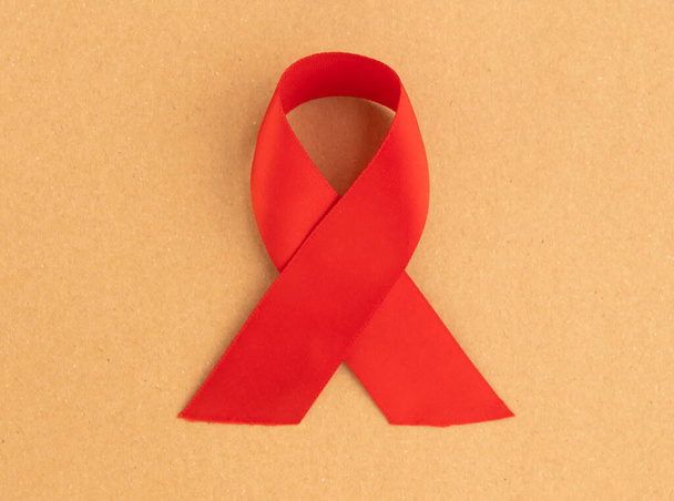Red satin ribbon ith loop as symbol of HIV and AIDS awareness day in December 1st - Photo, image