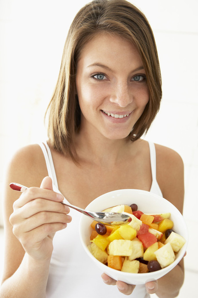Young Woman Eating Fresh Fruit Salad - Photo, Image