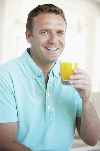Mid Adult Man Drinking Orange Juice - Foto, imagen