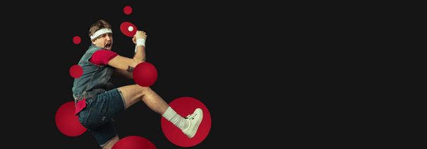 Young funny Caucasian man playing ping pong isolated on black background. Flyer - 写真・画像