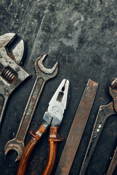 Old hardware tools. Wrench, screwdriver, measure, hammer, pliers on steel surface. Mechanic tools for maintenance. Hardware tools to fix. Technical background with copy space - Фото, зображення