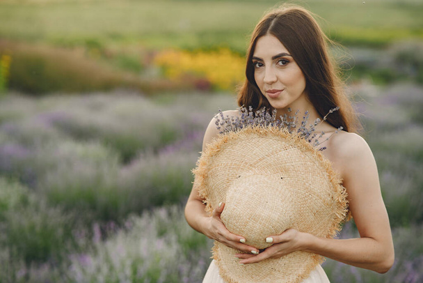 Woman without bra standing in a lavender field - Foto, immagini