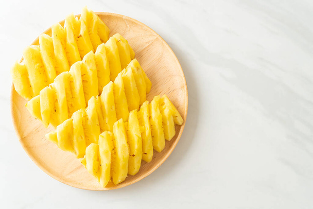 fresh pineapple sliced on wooden plate - Fotografie, Obrázek