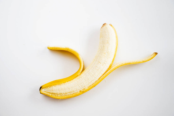A ripe peeled banana isolated on a white background - Фото, зображення